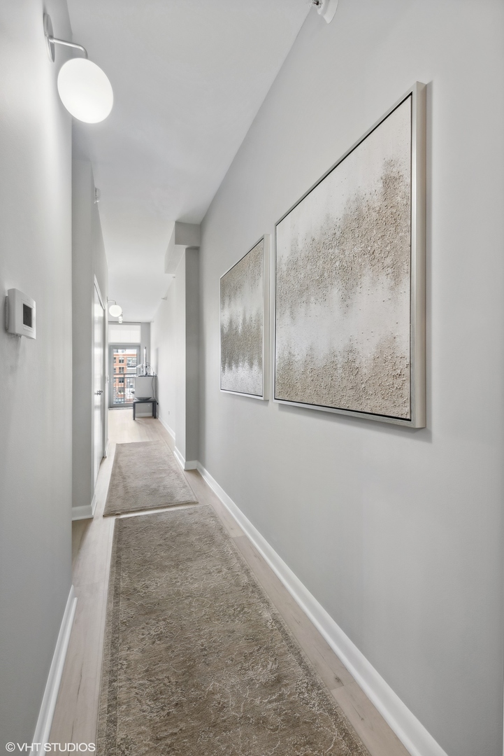 1200 West Monroe Street, Unit 619 Chicago, IL 60607 - Photo 8 of 16 a view of hallway with wooden floor