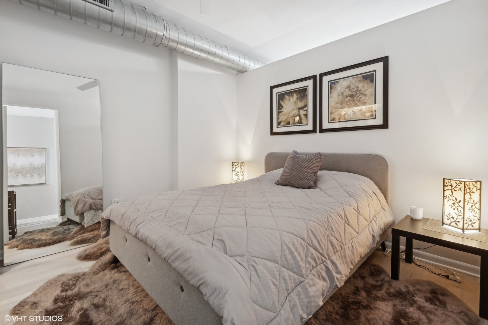 1200 West Monroe Street, Unit 619 Chicago, IL 60607 - Photo 9 of 16 a bedroom with bed and painting on the wall