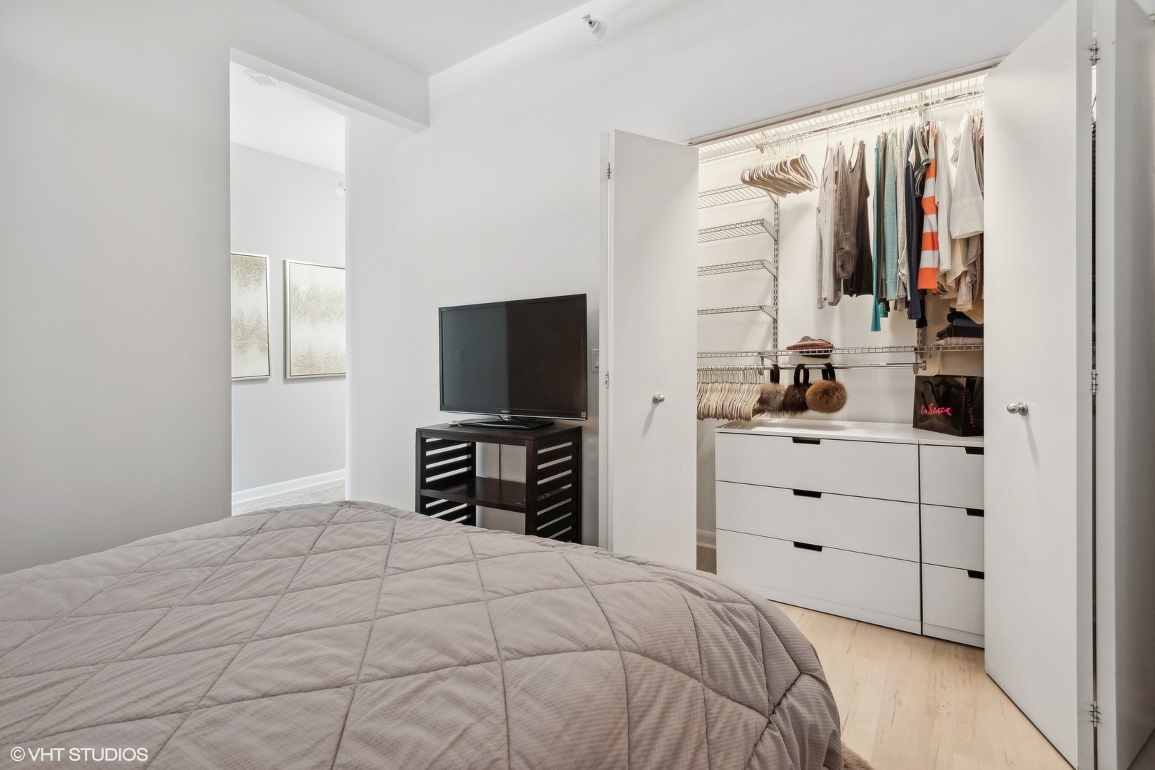 1200 West Monroe Street, Unit 619 Chicago, IL 60607 - Photo 10 of 16 a bedroom with a bed and a flat tv screen in it