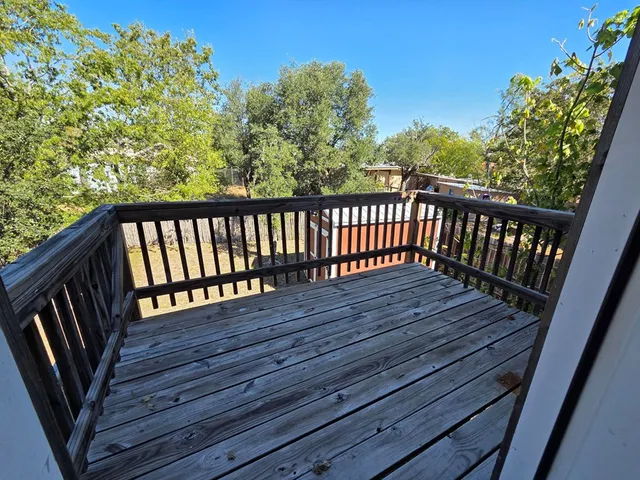 a view of a balcony with wooden floor