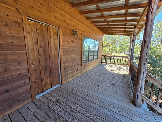 a view of outdoor space with wooden floor