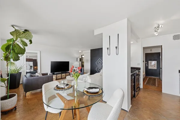 a dining room with furniture and wooden floor