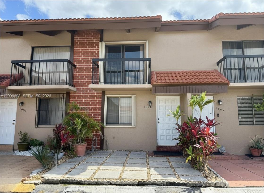 1911 Southwest 107th Avenue, Unit 1006 Miami, FL 33165 - Photo 1 of 17 a front view of a house