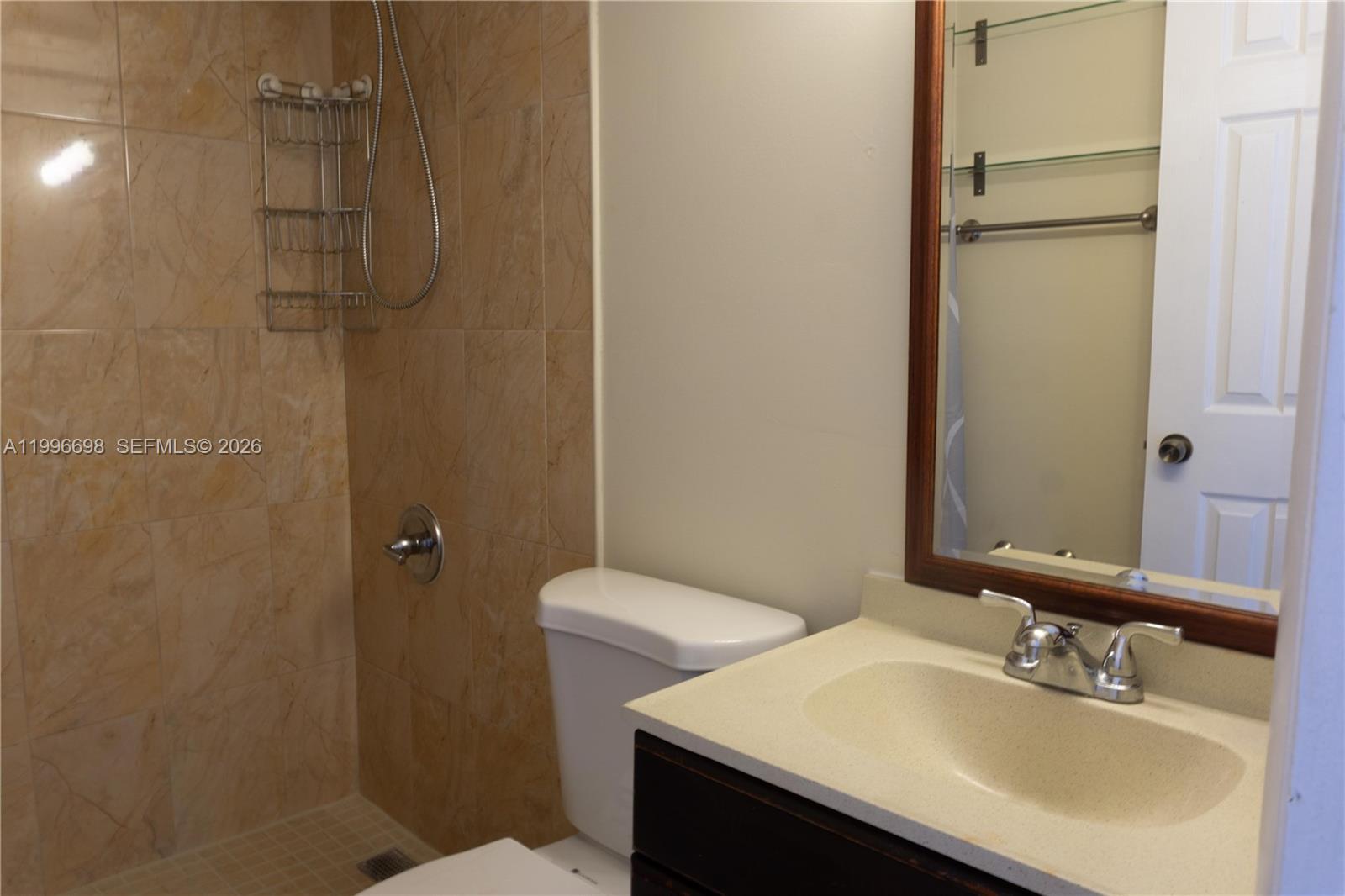 1911 Southwest 107th Avenue, Unit 1006 Miami, FL 33165 - Photo 11 of 17 a bathroom with a sink toilet and shower