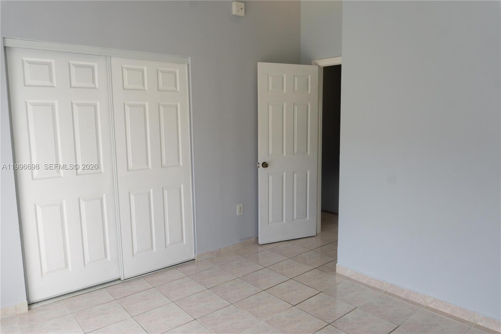 1911 Southwest 107th Avenue, Unit 1006 Miami, FL 33165 - Photo 14 of 17 an empty room with windows