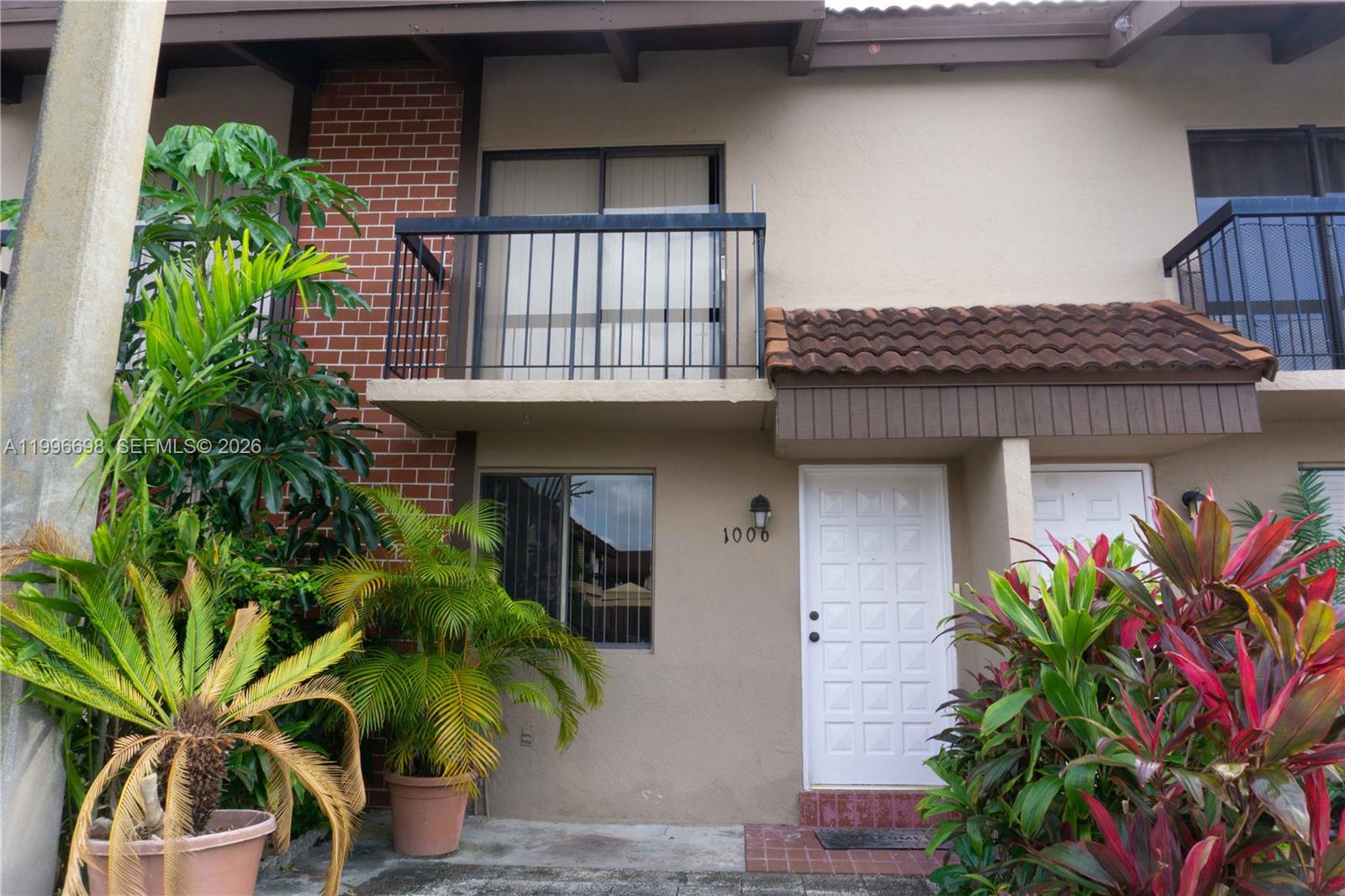 1911 Southwest 107th Avenue, Unit 1006 Miami, FL 33165 - Photo 17 of 17 a potted plant sitting in front of a building