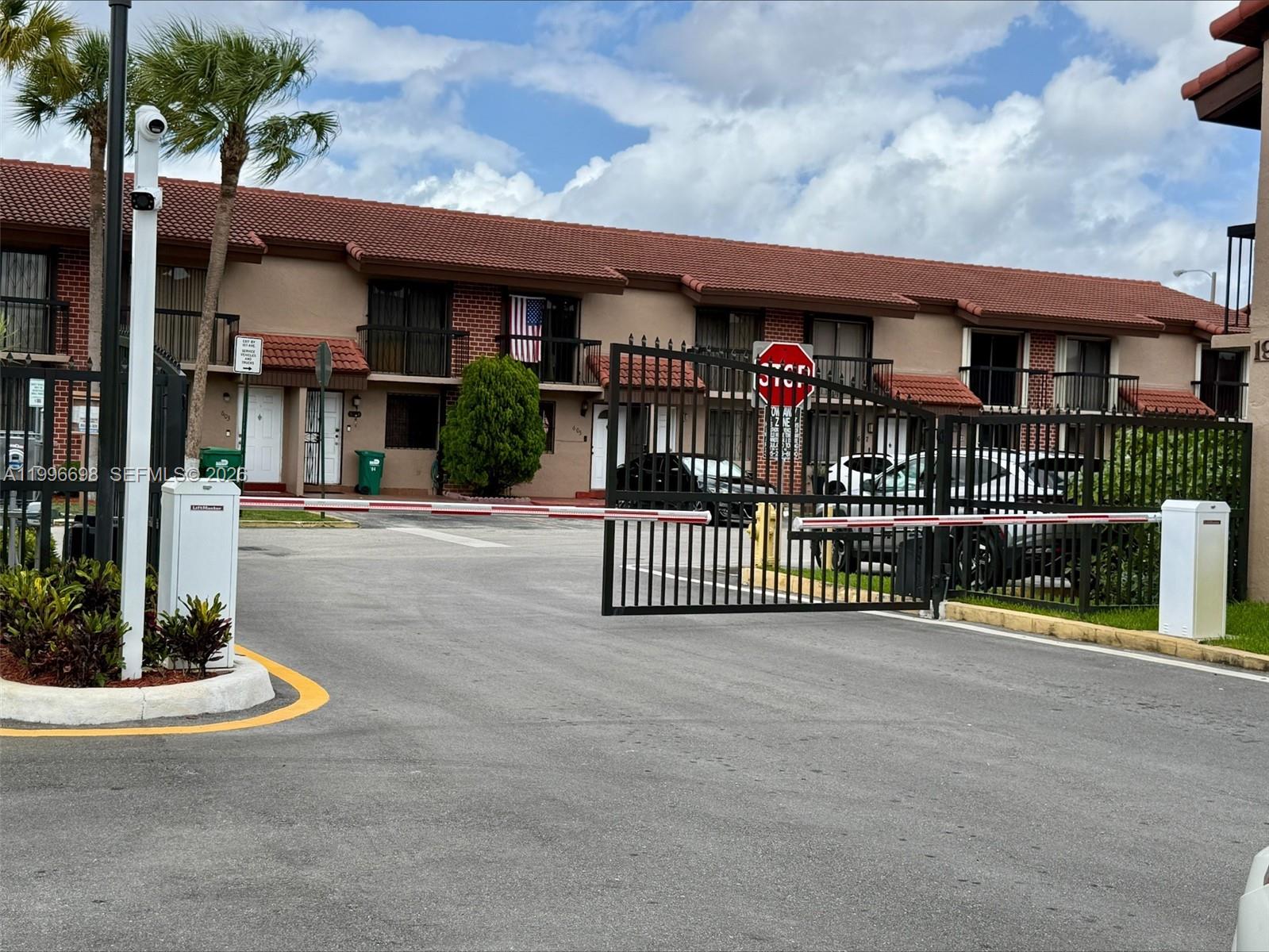1911 Southwest 107th Avenue, Unit 1006 Miami, FL 33165 - Photo 2 of 17 a view of a brick house with many windows and a table