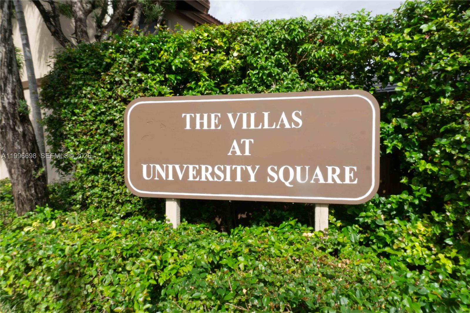 1911 Southwest 107th Avenue, Unit 1006 Miami, FL 33165 - Photo 3 of 17 a sign broad in front of flowers
