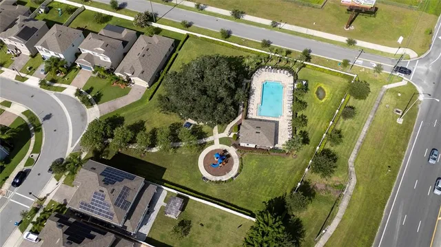 an aerial view of a residential houses with yard