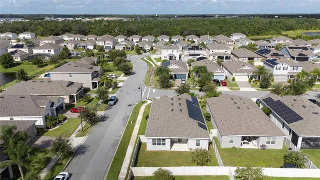 an aerial view of swimming pool with outdoor seating and city view