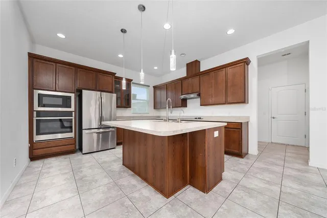 a kitchen with stainless steel appliances granite countertop a sink stove and cabinets