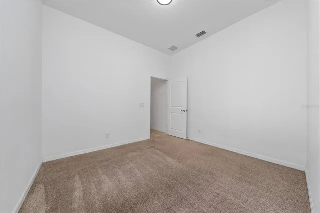 a bathroom with a granite countertop sink a toilet and a mirror