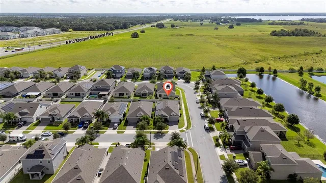 an aerial view of ocean and residential houses with outdoor space