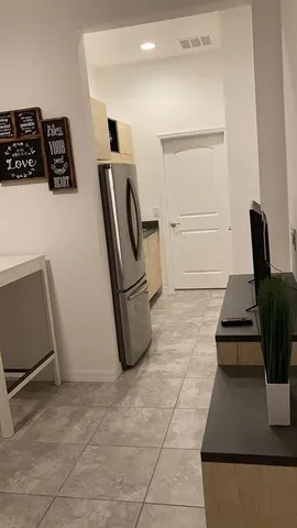 a bedroom with a bed and a night stand