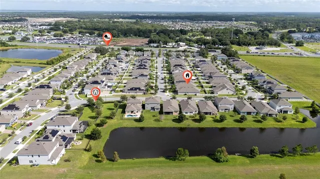 an aerial view of a house with a yard and lake view