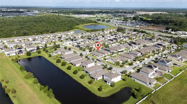 an aerial view of a house with a yard lake view and mountain view