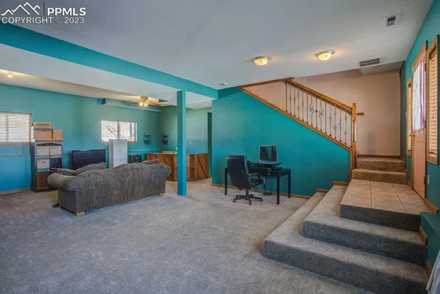 a bedroom with a bed a lamp and a potted plant