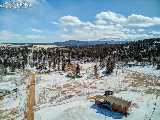 a view of a terrace with chairs and wooden fence