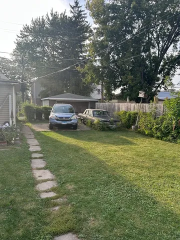 a view of a car park in front of a house