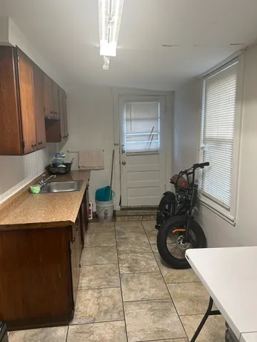 a room with furniture a flat screen tv and a window