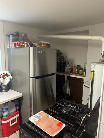 a kitchen with a refrigerator and a stove