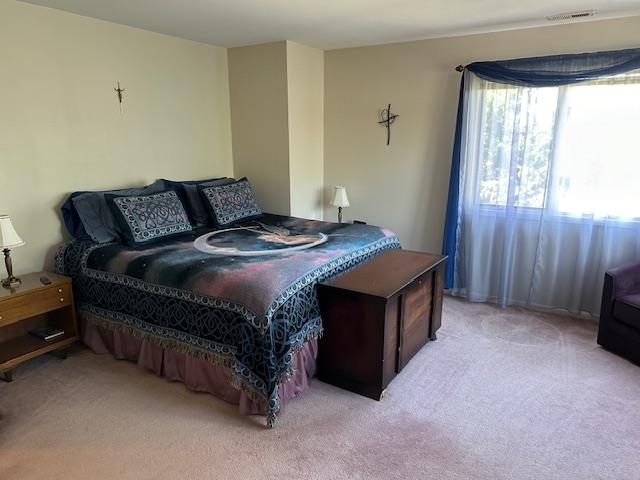 700 10th Street, Unit 12 Secaucus, NJ 07094 - Photo 6 of 13 a bed sitting in a bedroom next to a window