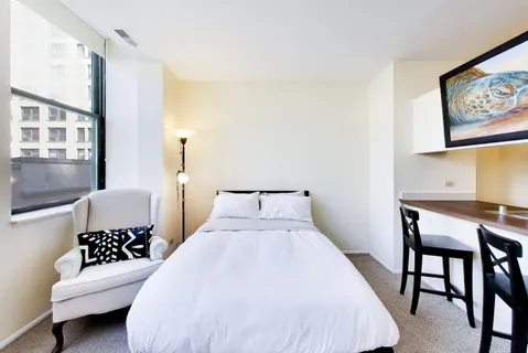 a bedroom with a bed and a table in it