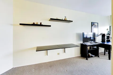 a view of workspace with chair and white wall
