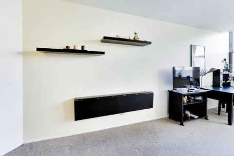 a view of a workspace with furniture and a lamp