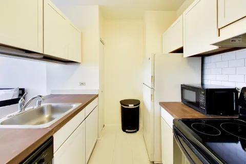 a kitchen with stainless steel appliances a sink a stove and a microwave
