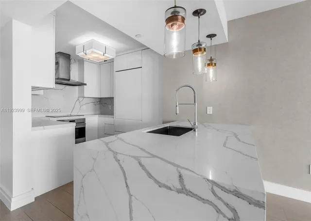 a kitchen with a sink a stove and cabinets