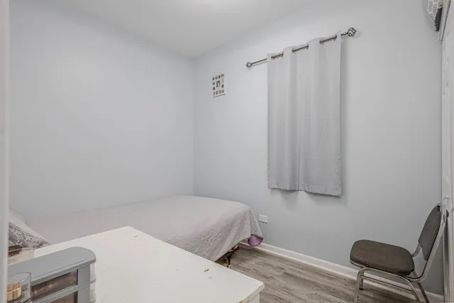 a bedroom with a bed and a chair