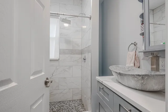 a kitchen with a granite countertop sink a toilet and shower