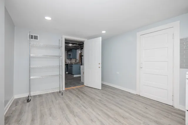 an empty room with closet and wooden floor