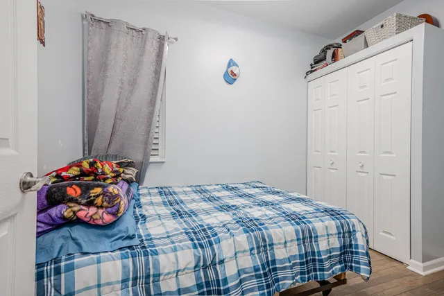 a bedroom with a bed and a window