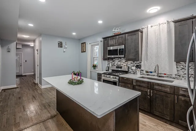 a kitchen with a sink stove and refrigerator