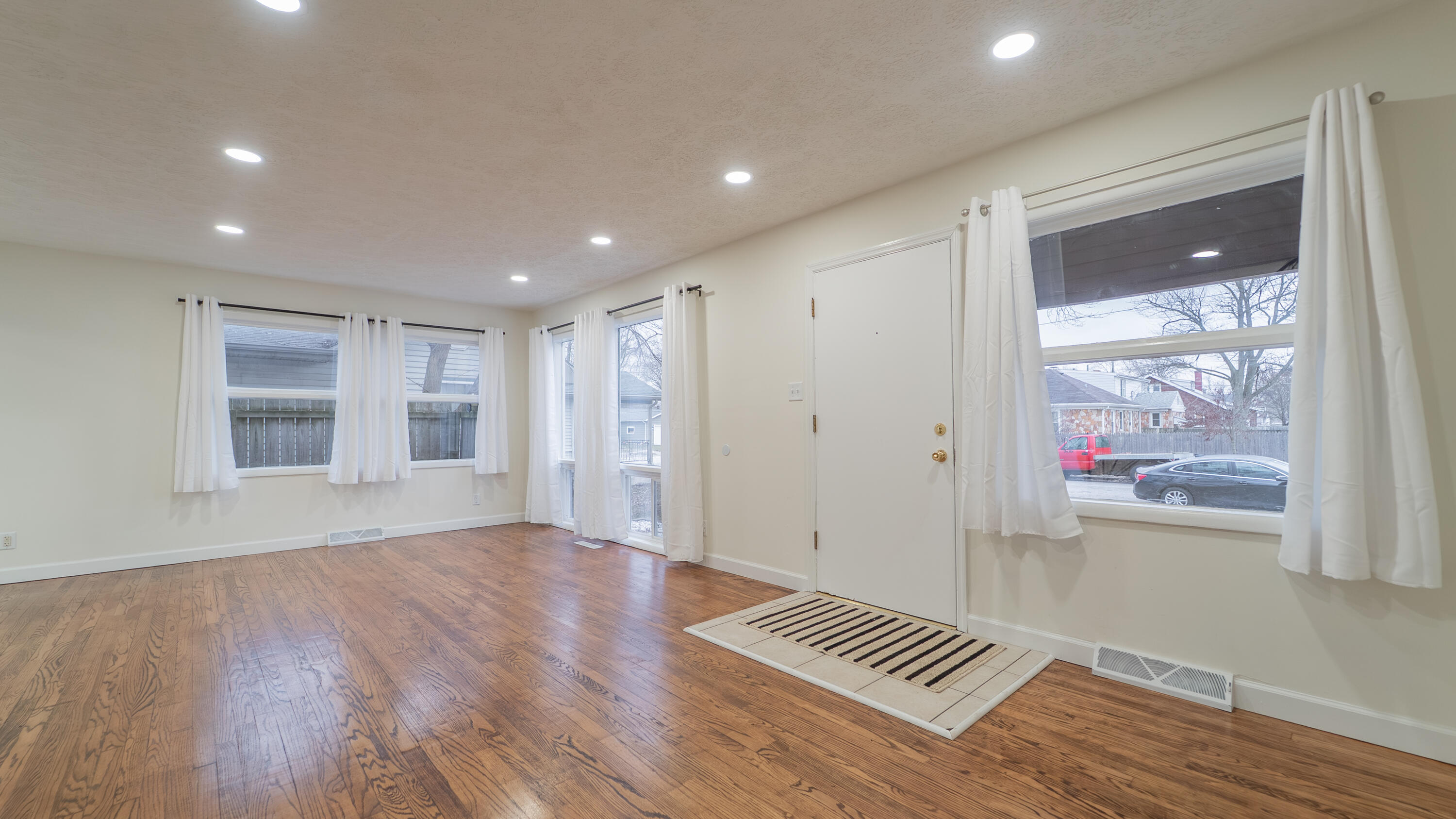 722 Madison Street Michigan City, IN 46360 - Photo 11 of 43 a view of wooden floor and windows in a room