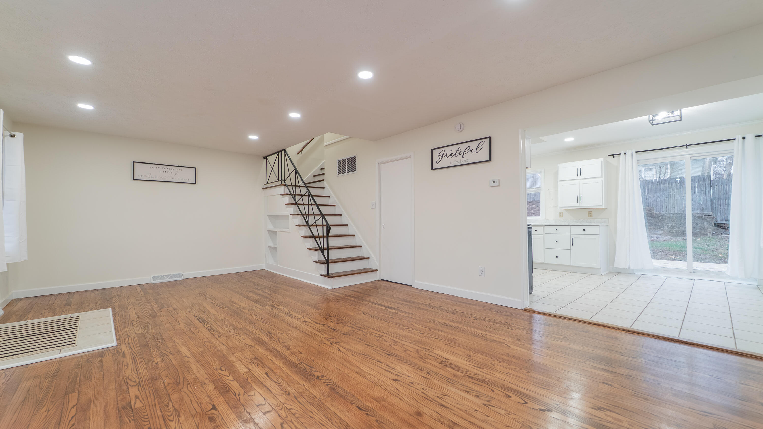 722 Madison Street Michigan City, IN 46360 - Photo 12 of 43 a view of an empty room with wooden floor and windows