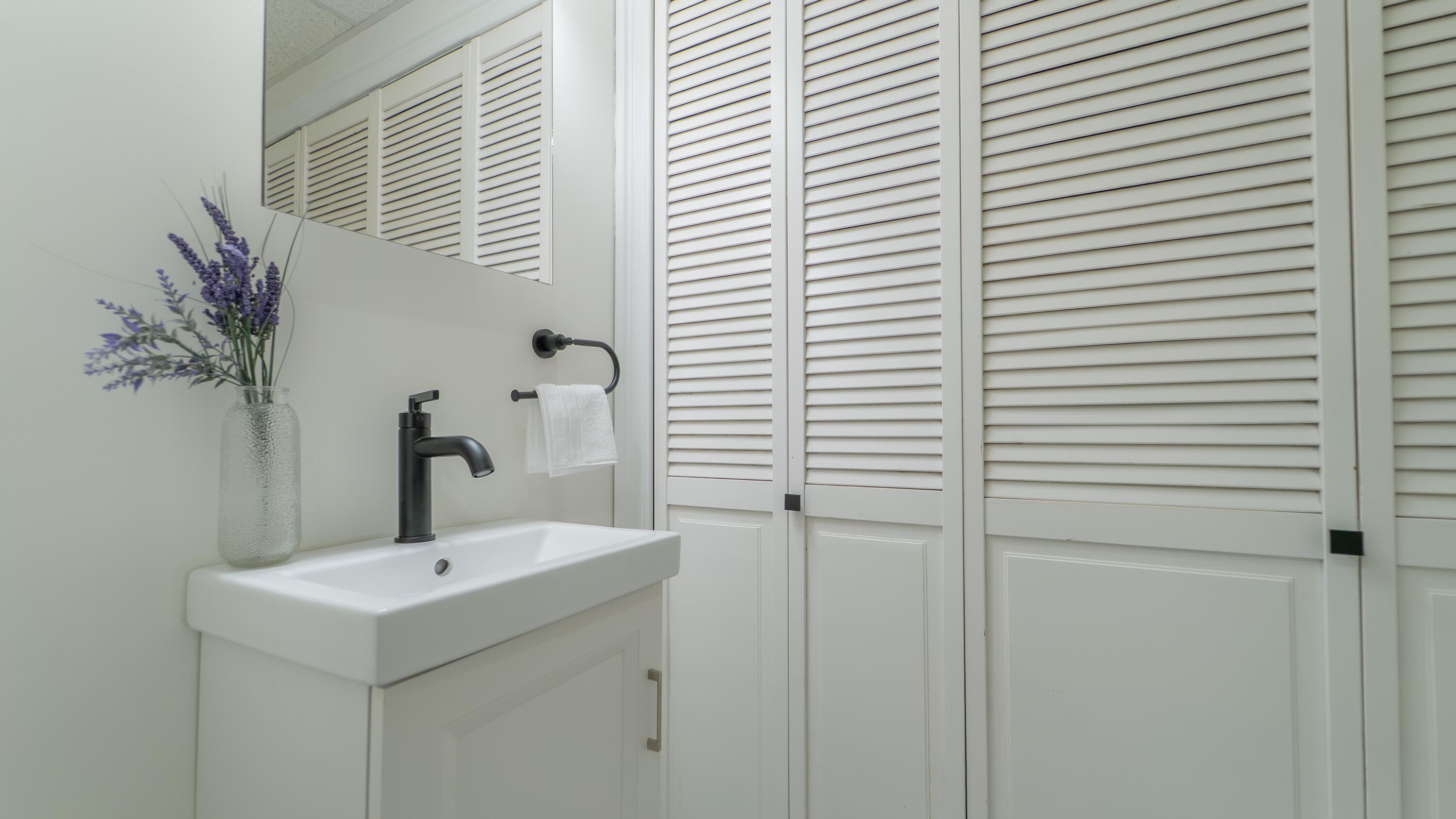 722 Madison Street Michigan City, IN 46360 - Photo 22 of 43 a bathroom with a sink and mirror