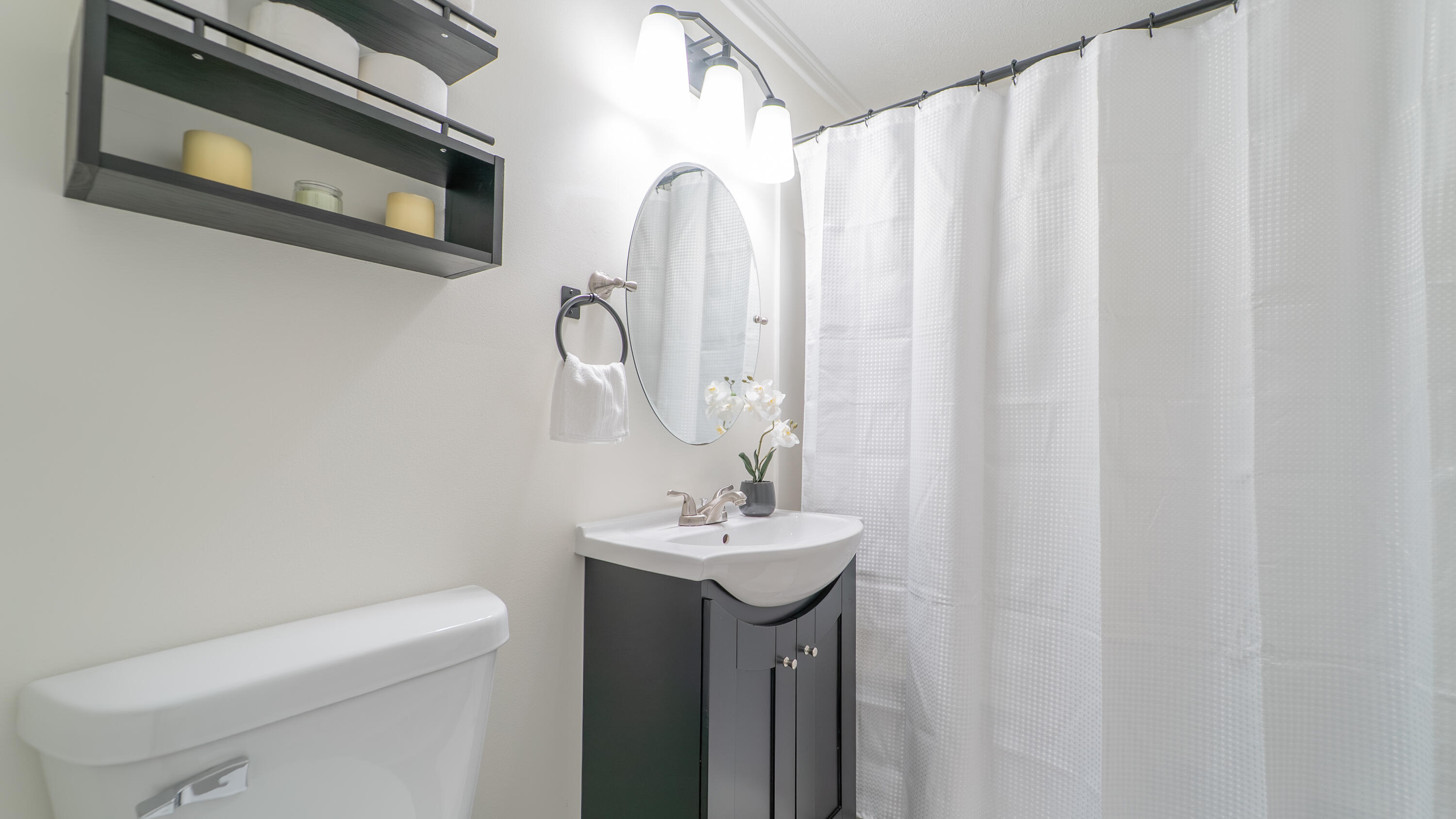 722 Madison Street Michigan City, IN 46360 - Photo 33 of 43 a bathroom with a sink a toilet and a mirror