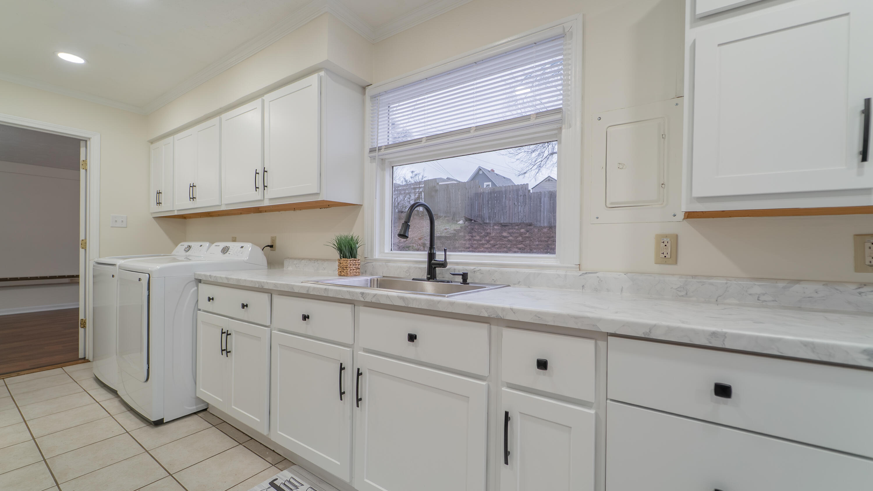 722 Madison Street Michigan City, IN 46360 - Photo 5 of 43 a kitchen with granite countertop white cabinets white appliances and a sink