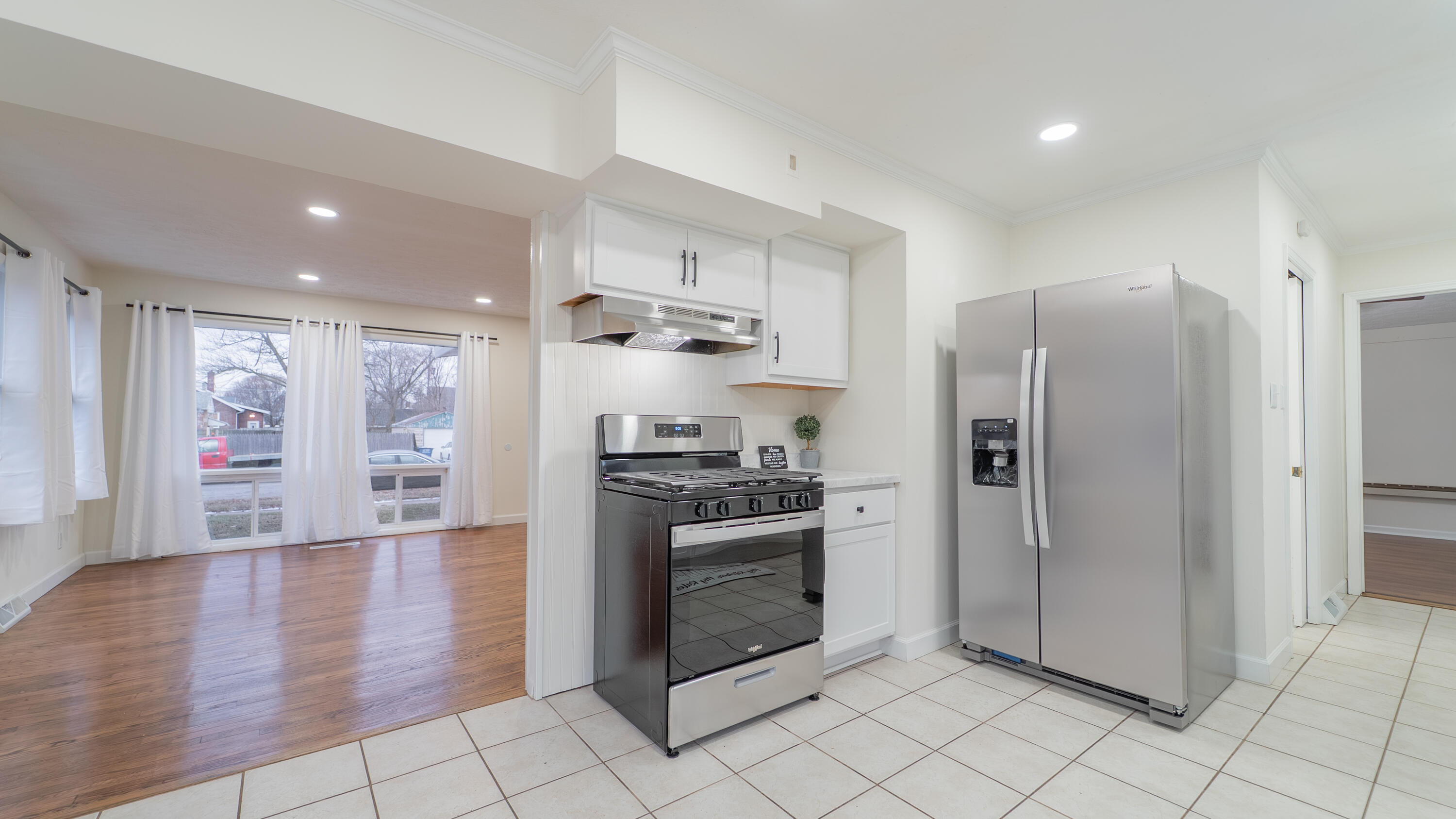 722 Madison Street Michigan City, IN 46360 - Photo 6 of 43 a kitchen with stainless steel appliances granite countertop a refrigerator and a stove top oven