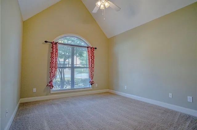 an empty room with windows and cabinet