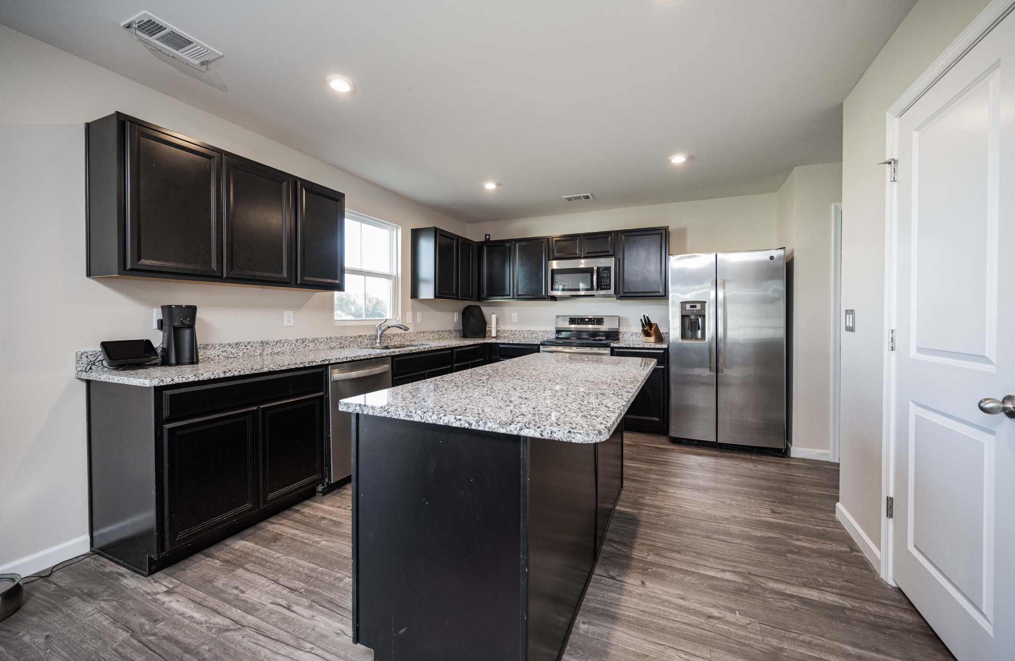 5531 Compass Way Christiana, TN 37037 - Photo 6 of 21 a kitchen with granite countertop stainless steel appliances and wooden cabinets