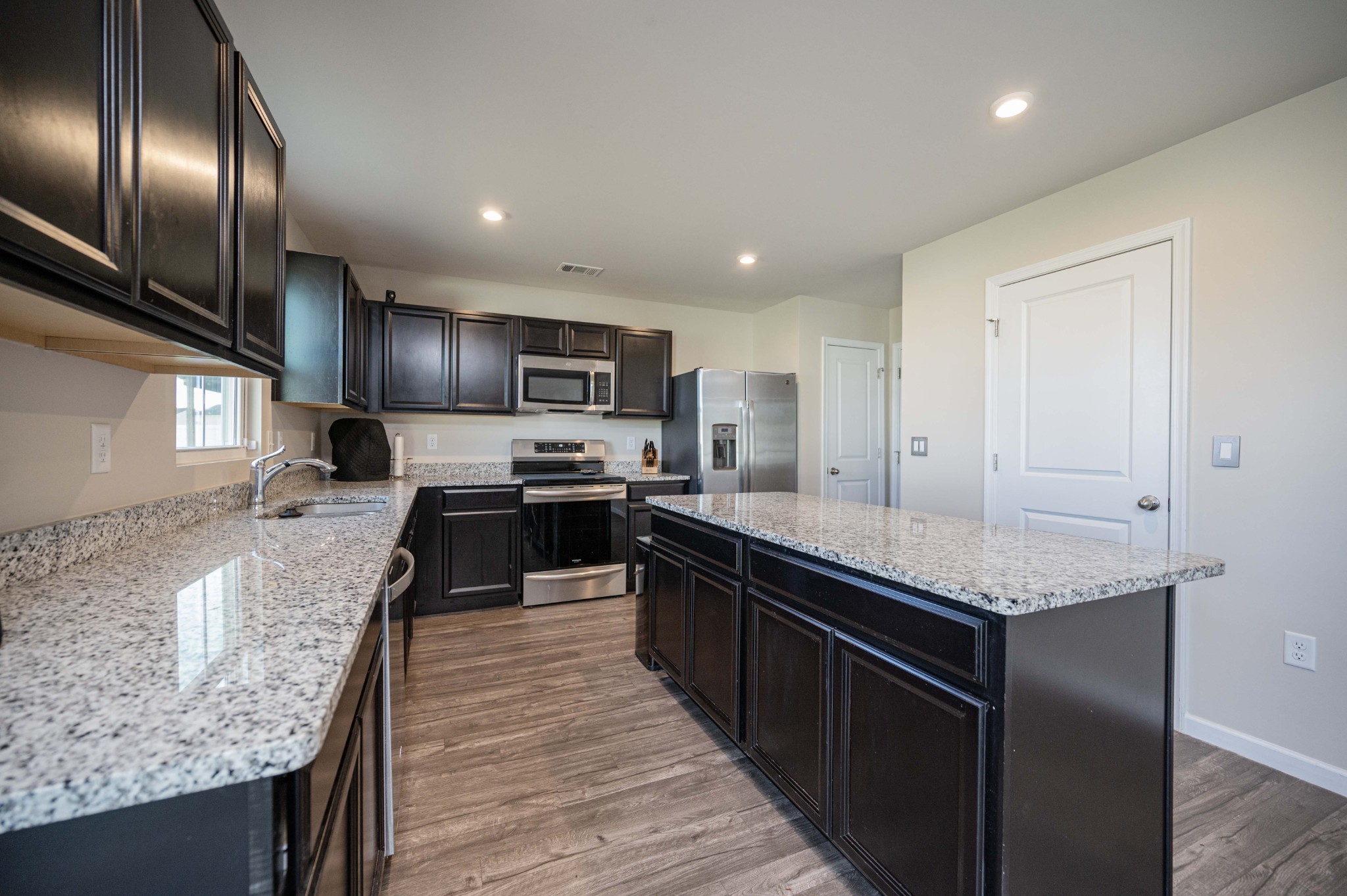 5531 Compass Way Christiana, TN 37037 - Photo 7 of 21 a large kitchen with granite countertop lots of counter top space a sink and stainless steel appliances