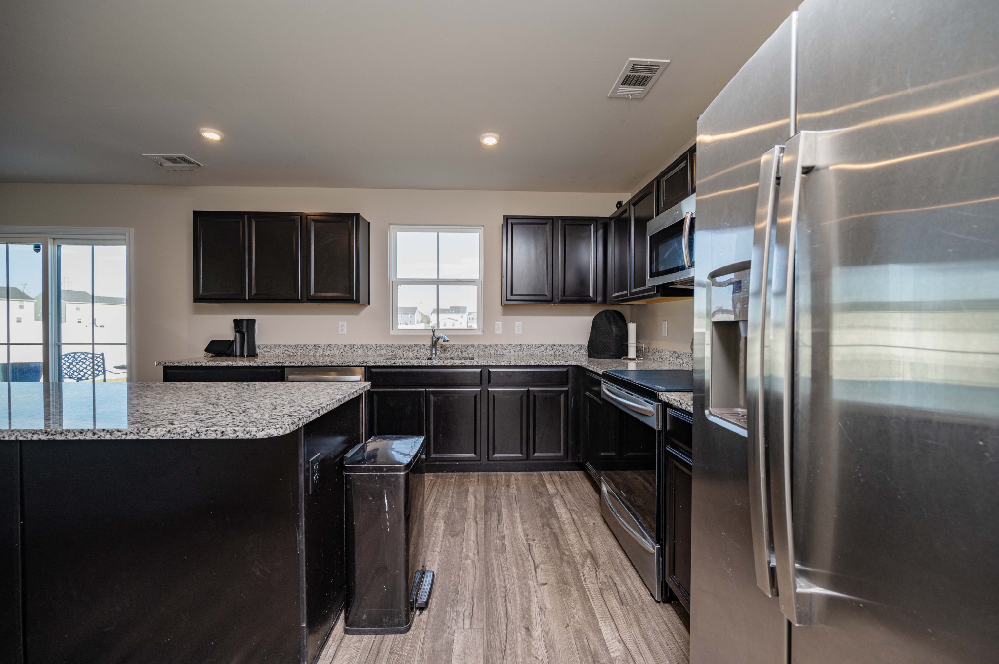 5531 Compass Way Christiana, TN 37037 - Photo 8 of 21 a kitchen with stainless steel appliances granite countertop a refrigerator a sink and wooden cabinets