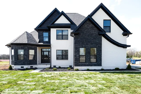 a view of a house with pool and a yard