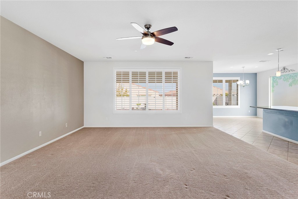 18968 Raven Street Apple Valley, CA 92308 - Photo 11 of 53 an empty room with windows and ceiling fan