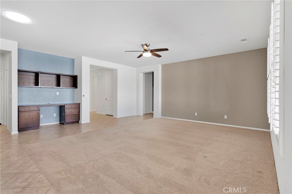 18968 Raven Street Apple Valley, CA 92308 - Photo 15 of 53 a view of a kitchen with a sink and a chandelier fan