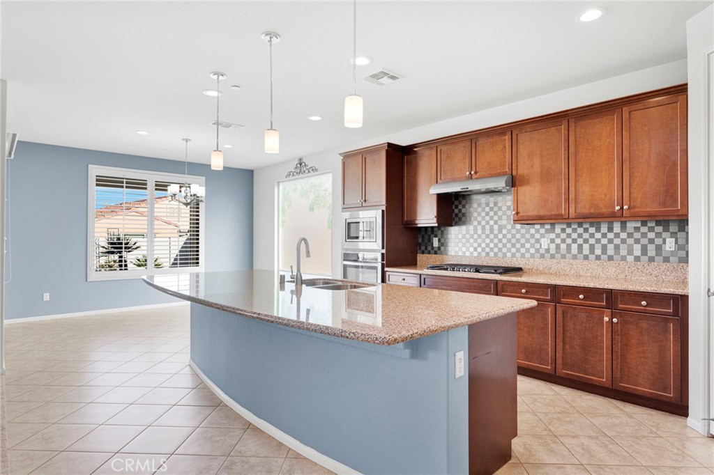 18968 Raven Street Apple Valley, CA 92308 - Photo 18 of 53 a large kitchen with granite countertop a sink and a stove